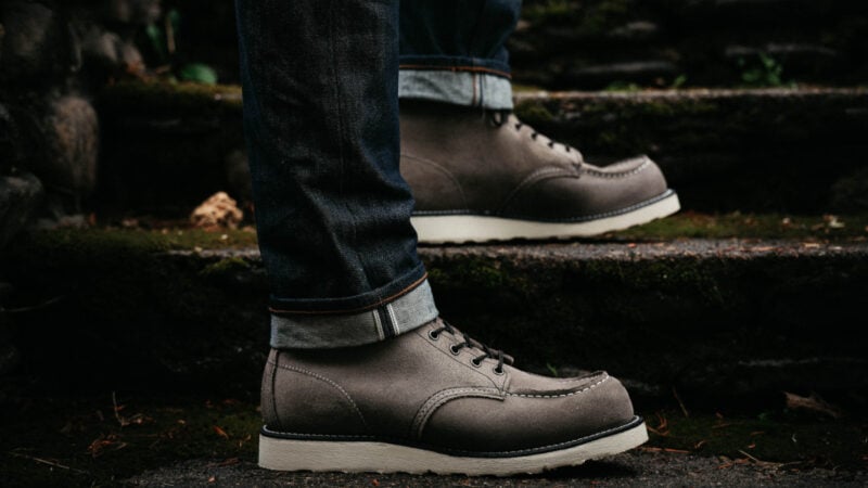 Model wearing Red Wing Moc Toe boots on the stairs outside