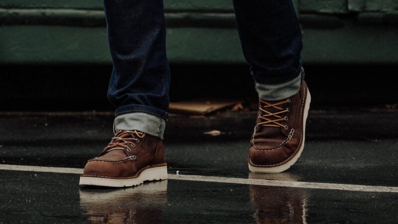 Model wearing Danner Bull Run on a wet surface